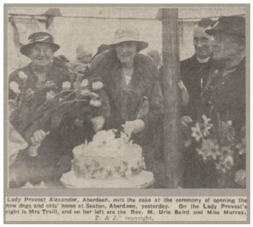 Newspaper cutting showing the cutting of a cake.